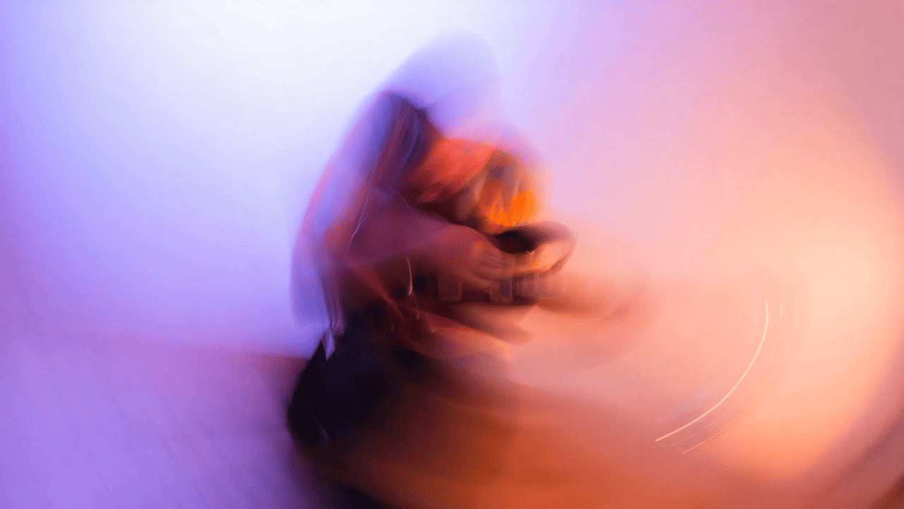 Abstract blurred person playing guitar with vibrant colors